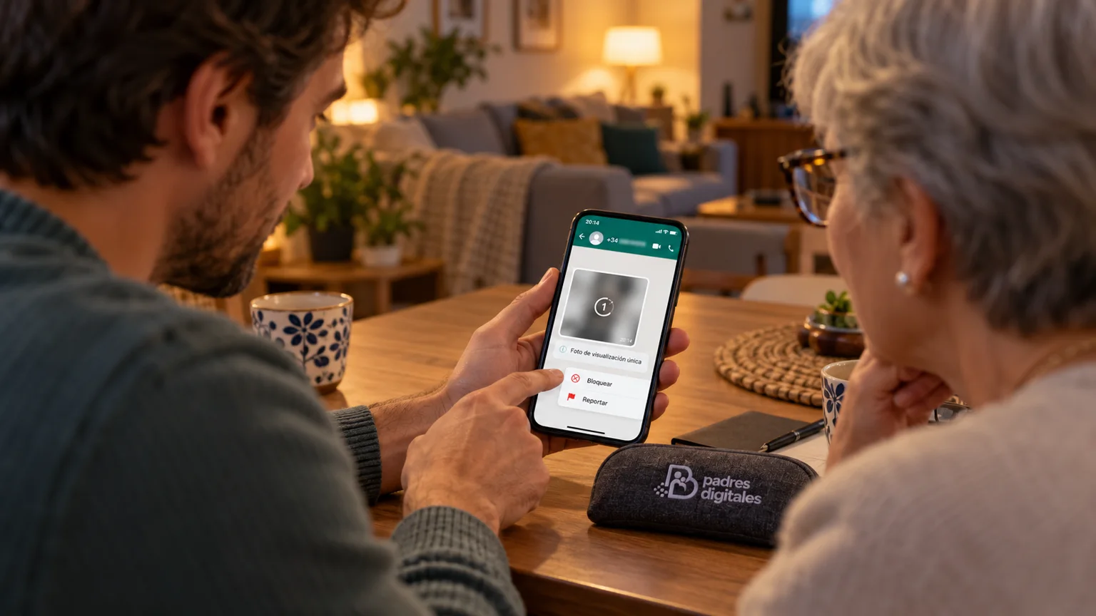 Familia revisando cómo bloquear y reportar una foto de visualización única sospechosa en WhatsApp, con logotipo oficial de Padres Digitales integrado en una funda